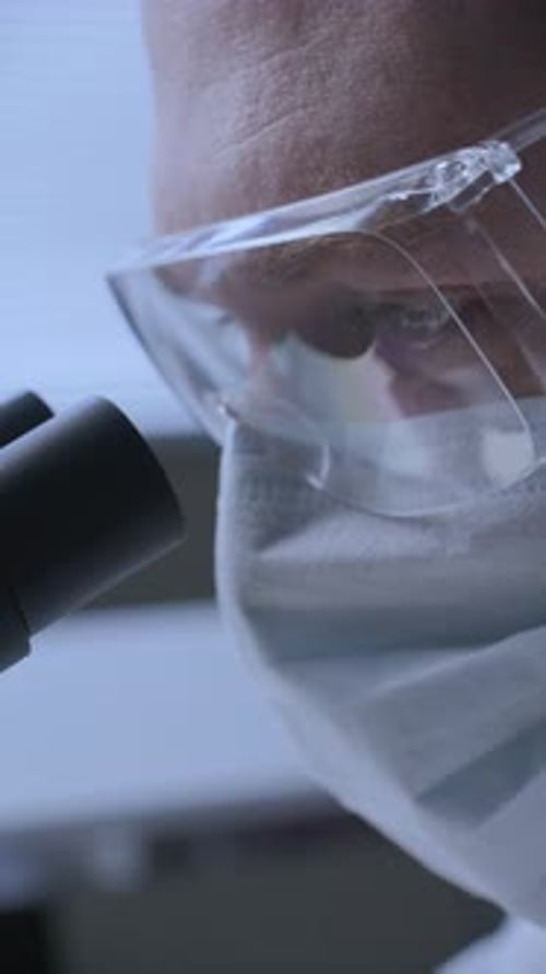 Focused Male Lab Technician Conducting Microscopic Analysis