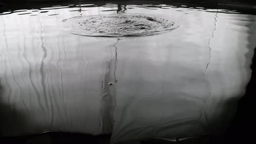 Abyss Collection: Rippling effect on a big pool of water with bubbles coming out over a black backgr