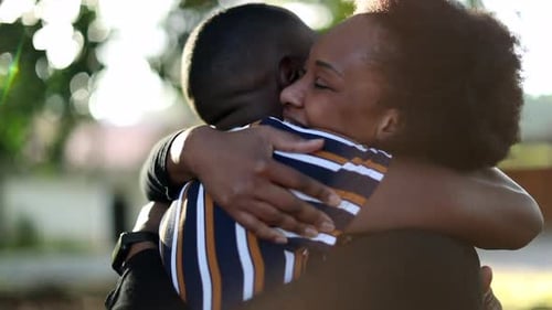 Happy Couple Embrace in Golden Sunlight Outdoors