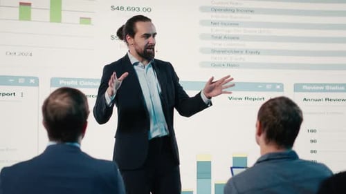 Man Giving Presentation With Financial Charts and Graphs