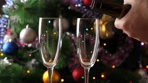 Pouring Champagne into Glass for Christmas Celebration