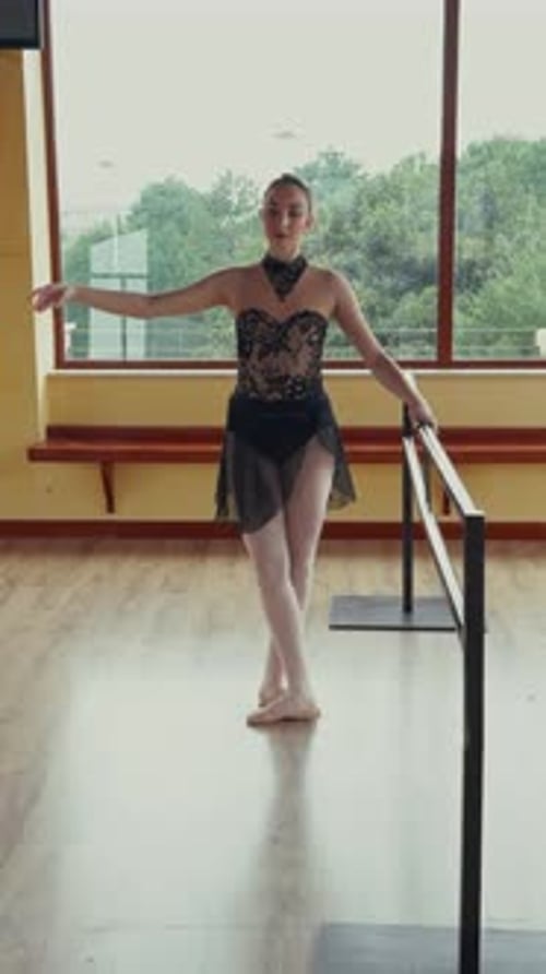 Graceful Dancer Practices Ballet at the Barre
