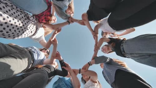 A Group of Girls Makes a Circle Shape Holding Each Other's Hands