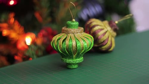 Glitter foam christmas ornaments, on a green cutting mat. Beautiful Xmas decorations.