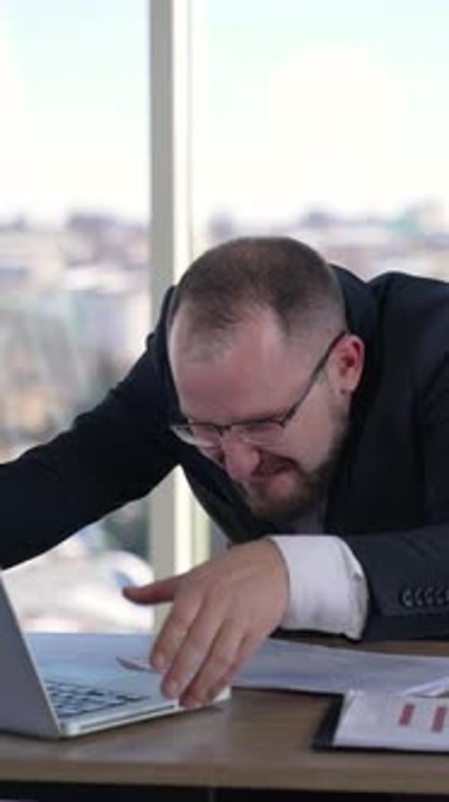 Man Screaming at Laptop in Frustration