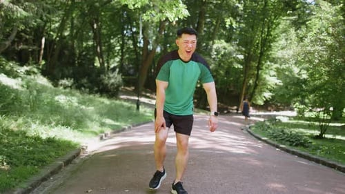 Chinese Runner Sportsman with Muscle Knee Pain in Park Trauma Injury While Jogging Leg Muscle Cramp