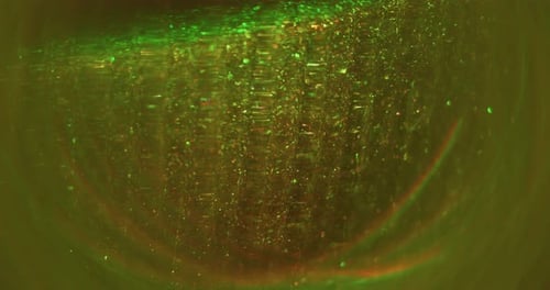 Abstract glittering light effects with green and orange hues