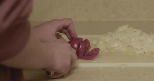 Chopping Red Onion on a Cutting Board