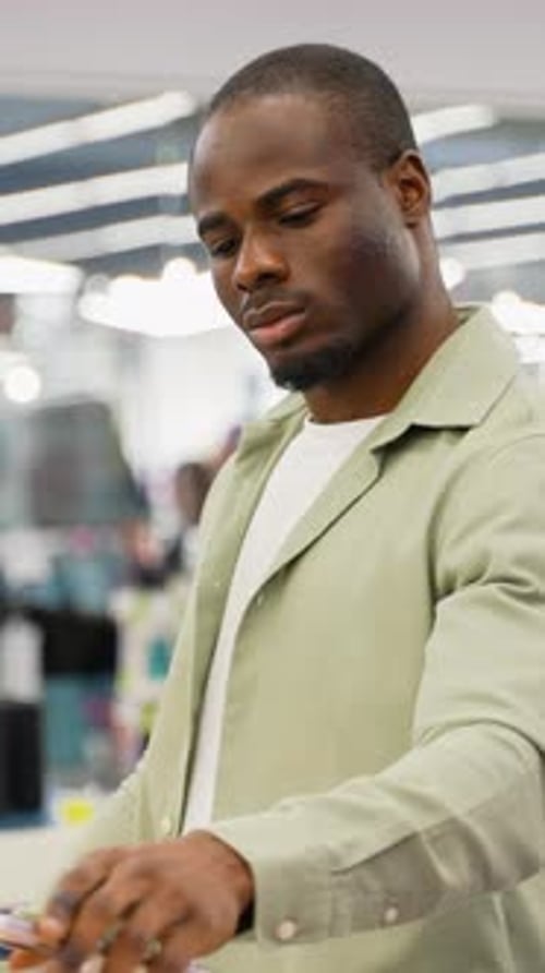 Customer Using Self Checkout Kiosk in Retail Store with Discount