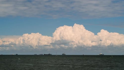 Timelapse Movement of Cumulus Rain Clouds Over the Sea with Ships