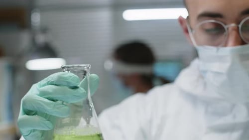 Scientist mixing chemicals in laboratory experiment
