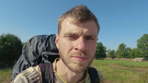 Man with Backpack Outdoors on a Sunny Day