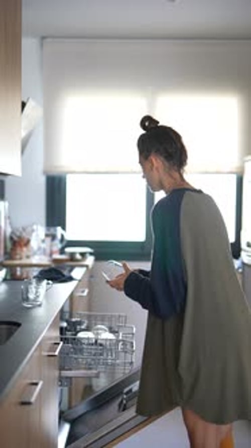 Woman Setting Up Dishwasher and Arranging Cabinets Organizing Kitchen for Efficiency
