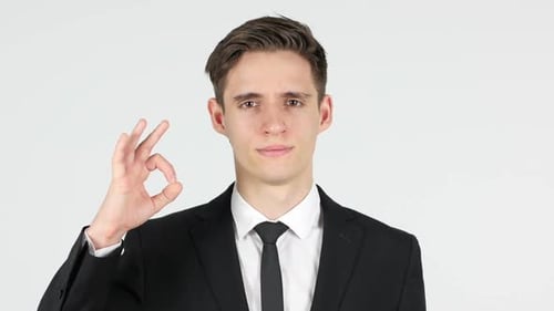 Man in Suit Makes Okay Hand Gesture