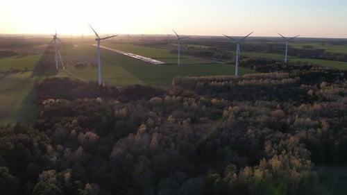 wind turbine farm at sunset, green energy, future electricity, aerial footage.