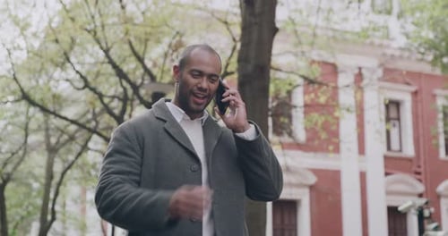 Talking, walking and casual man on a phone call looking and checking his watch for the time