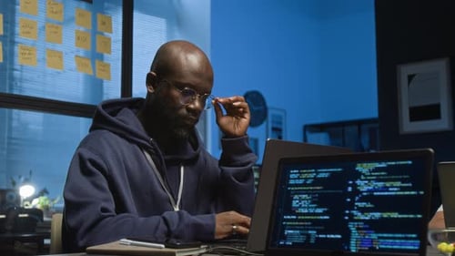 Tired Software Engineer Taking off Glasses, Rubbing Eyes and Continuing Working