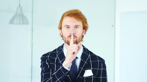 Gesture of Silence By Young Man Finger on Lips