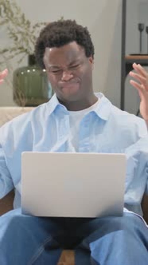 Adult Working on Laptop Looking Frustrated
