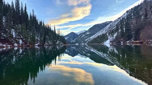 LOW view of the Big Almaty Lake in summer. The water of the lake is cloudy due to the active melting
