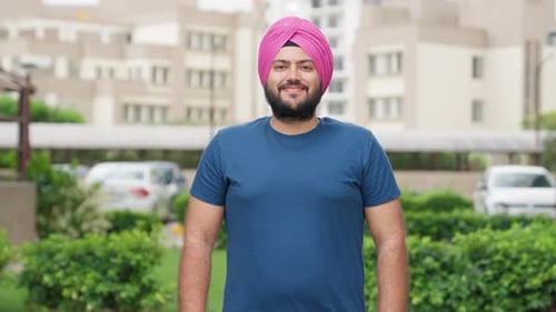 Smiling Man With Turban Standing Outdoors
