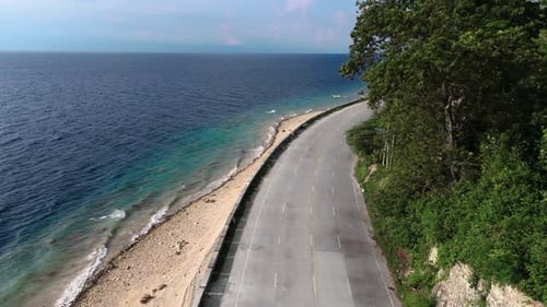 Drone view of right curve at coast road in the Philippines
