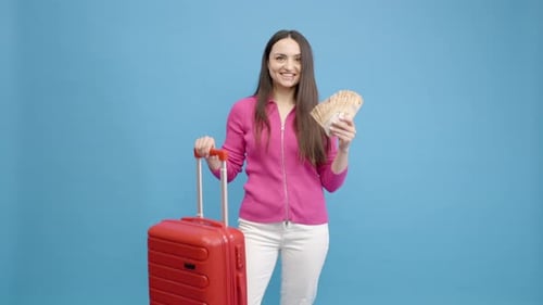 Excited Woman with Suitcase and Money Ready to Travel