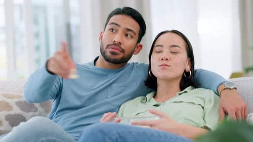 Couple Relaxing and Watching Television at Home