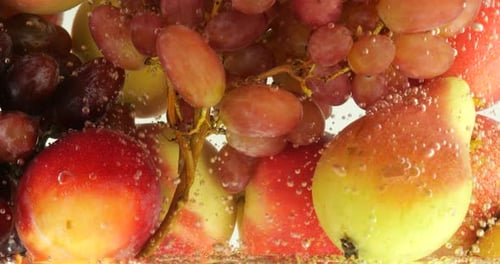 Background with fruits and berries in water with air bubbles.