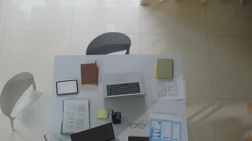 Laptops, Tablets and Documents on Worktable of IT Specialists