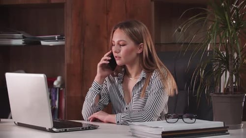 Woman Talking on Phone in Modern Office