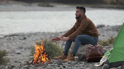 Hiker Tourist Traveler Man with Backpack Mountain Camping Fire Firewood Camp Tent Traveling Hiking