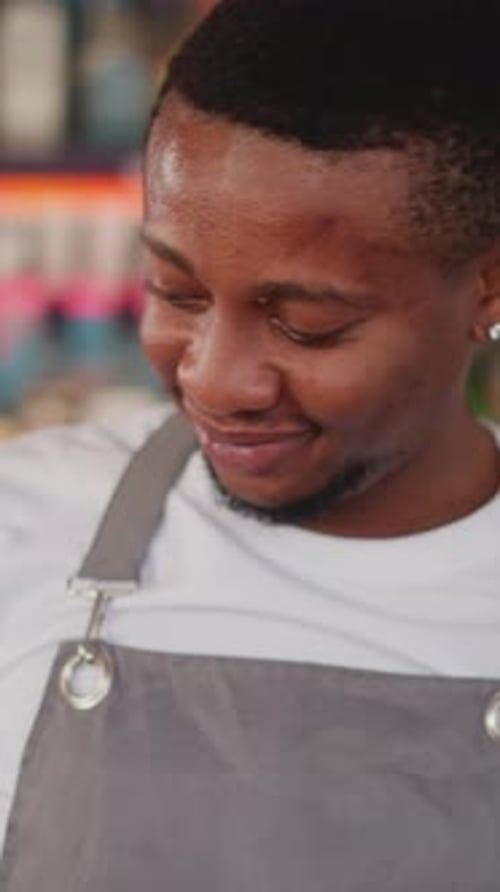 Barman Turns Metal Scoop at Counter Closeup
