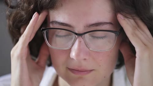 Woman Massaging Temples for Relaxation
