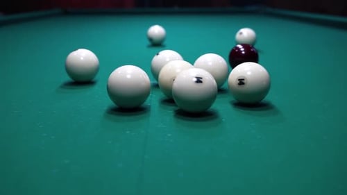 Man Breaking Pool Balls on Table