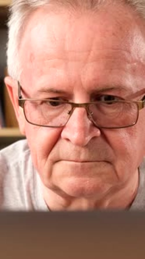 Portrait of a Tired Grandfather Who Has a Headache He Works at the Computer Vertical Video