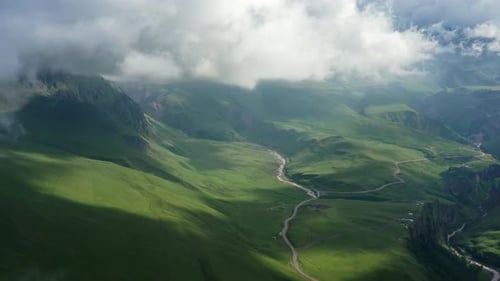 Verdant Mountain Valley Vista with River and Clouds
