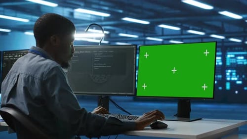 IT Technician Overseeing Supercomputers Using Chroma Key PC Monitor