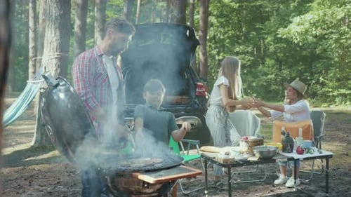 Outdoor Family Gathering Celebration Around Barbecue Area Friends and Family Enjoy Picnic in Nature