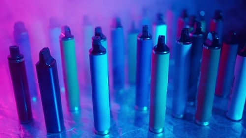 ECigarettes and Vapes with Smoke in Neon Lighting