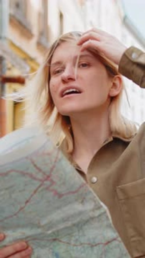 Woman looks at city map on European street