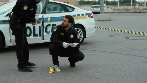 Police Officers Examining Crime Scene Evidence Outdoors