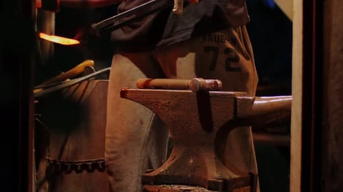 Blacksmith Shaping Hot Metal on Anvil