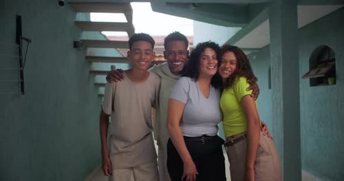 Smiling Family Poses Together in Indoor Home Setting