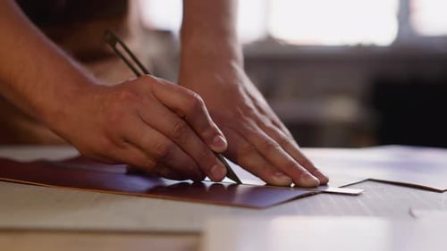 Hands Cutting Leather with Blade and Ruler