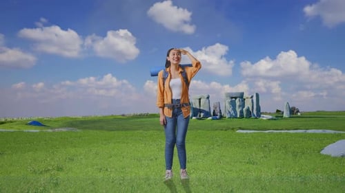 Woman Smiling on Green Field with Stonehenge