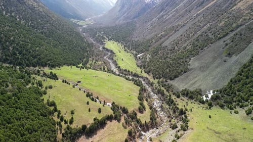 Alamedin Gorge, green valley with river, drone fly above shot
