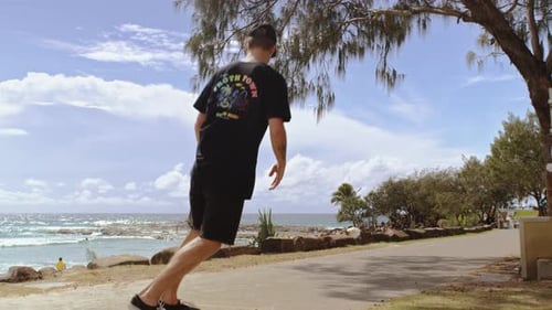 Skater at the Beach with Ocean in the Background Skating by Camera