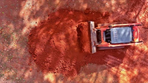Working on a Construction Site with a Bulldozer While Doing Landscaping Works with Earth Soil