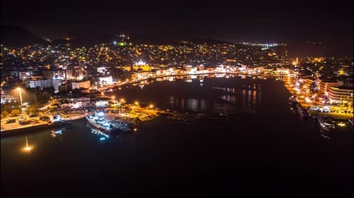 drone night hyperlapse coastal aerial shot timelapse highlighting the city lights and traffic.